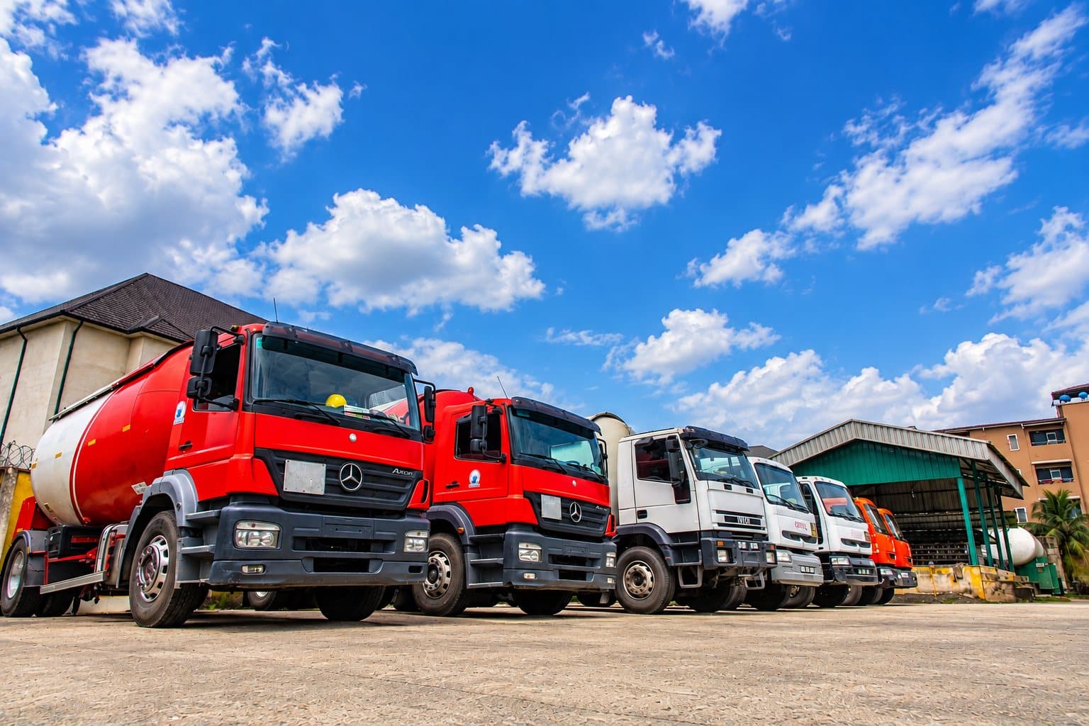 Red and white tanker trucks at the yard